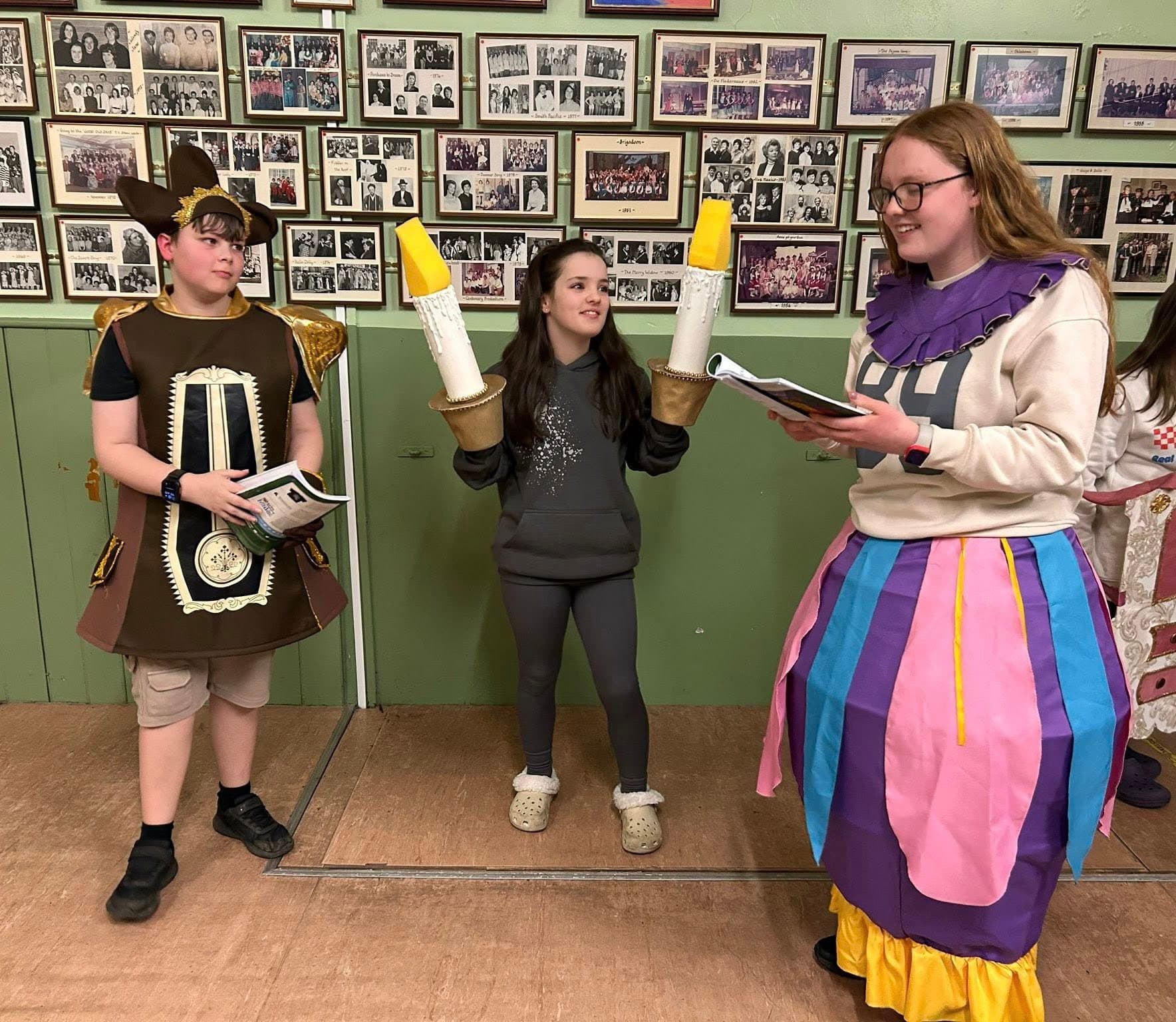 Cogsworth, Lumière and Mrs Potts in rehearsal with scripts